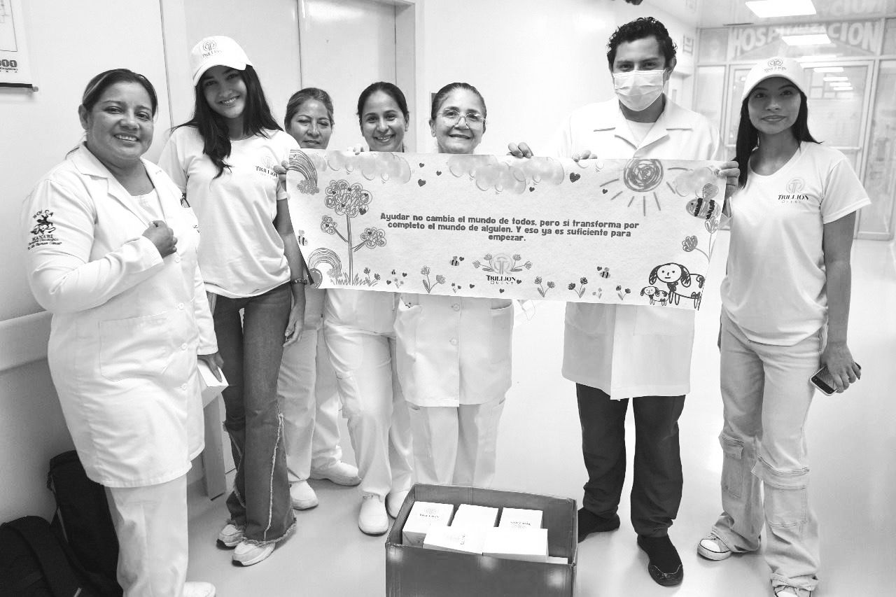 Trillion Quest team with banner at the hospital.