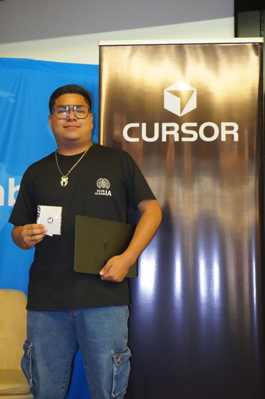 Josue Castro at a Cursor community event, holding an award